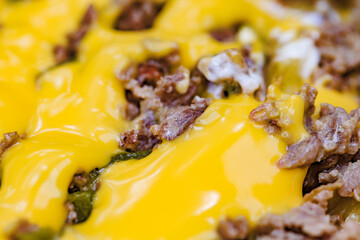 Grilled meat filled with melted cheese close-up, selective focus