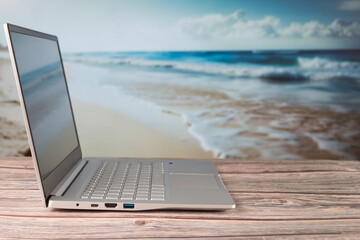 Computer work desk, with out-of-focus beach background