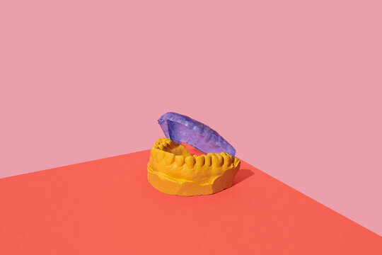 blue mouthguard in a yellow dental mold