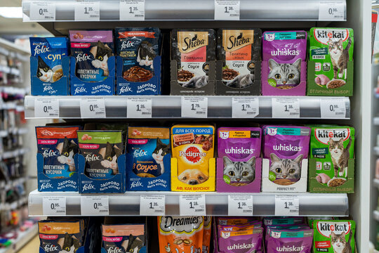 Various types of food for cats in packing sold on pet store shelf, packaged dry food, canned wet food. Minsk, Belarus, 2023