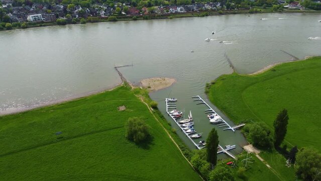 Drone shot of boats, speedboats, sailboats, ships and jetski in Hamm in Dusseldorf, Germany, on the Rhein river with the city skyline in the back, sailboats, boats