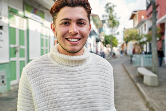 Happy young latino man looking at the camera