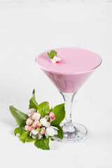 Pink tea matcha Panna Cotta in martini glass. Creamy Panna Cotta dessert with the addition of pink pitahaya powder. White background