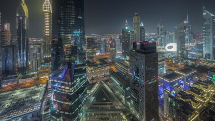 Panorama showing futuristic skyscrapers in financial district business center in Dubai night timelapse