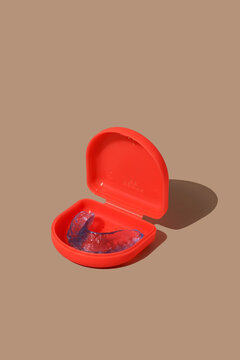 blue mouthguard in a red case