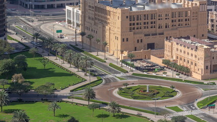 Obraz premium Aerial view of a roundabout circle road intersection in Dubai downtown from above timelapse.