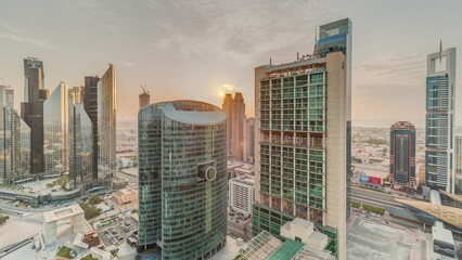 Sunset over Dubai international financial center skyscrapers aerial timelapse.