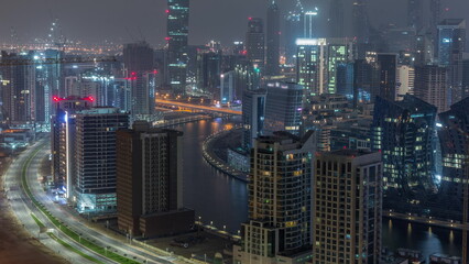 Obraz na płótnie Canvas Skyline with modern architecture of Dubai business bay towers all night timelapse. Aerial view