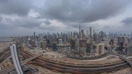 Obraz premium Panoramic skyline of Dubai with business bay and downtown district night to day timelapse.