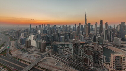Fototapeta na wymiar Skyline with modern architecture of Dubai business bay towers at sunset timelapse. Aerial view