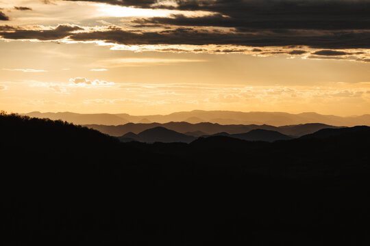 Hills And Mountains On The Horizon During Sunset.
