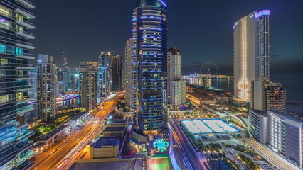 Fototapeta na wymiar Panoramic view of the Dubai Marina and JBR area and the famous Ferris Wheel aerial day to night timelapse