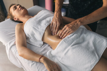 Therapist massaging a patient's stomach