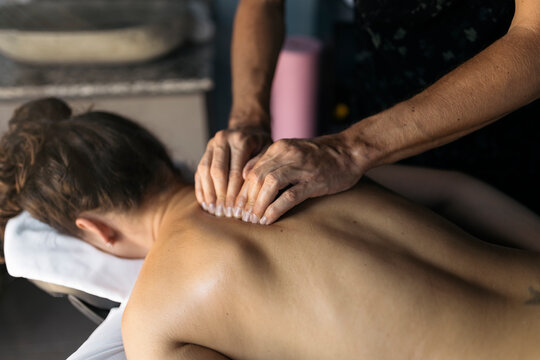 Physiotherapist treating the back of a patient