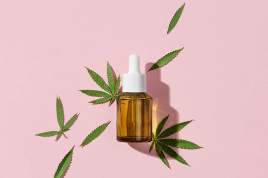 Cannabis oil extracts with hemp leaves background