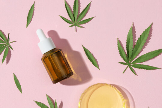 Cannabis oil extracts with hemp leaves background