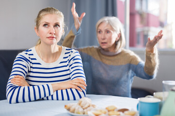 Elderly mother is aggressive against her adult daughter during a quarrel