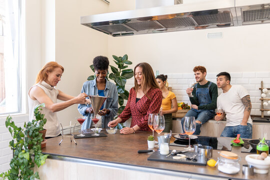 Multiracial Group Of Friends Cooking A Meal Together.