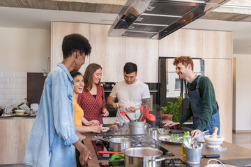 Multiracial Group Of Friends Cooking A Meal Together.