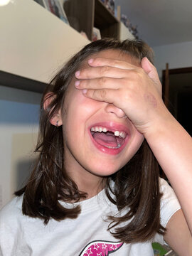 Girl smiling without a tooth