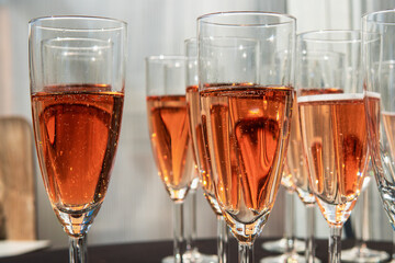 Festive glasses of delicious tasty red bubbly cava champagne on a wedding table. Wedding concept