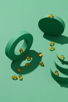 Yellow gelatin capsules on a green background