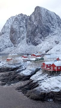 Famous iconic traditional fishing village Hamnoy on Lofoten Islands, Norway with red rorbu houses. With snow in winter