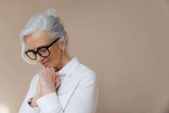 Woman in simple studio with serious expression.