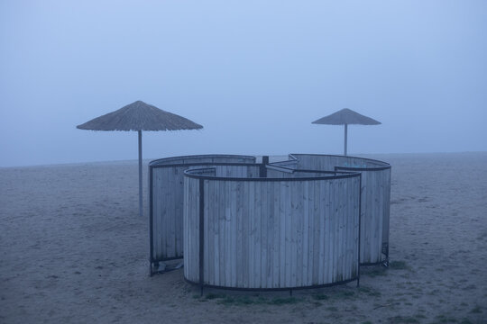 two umbrellas and a beach changing room on the beach