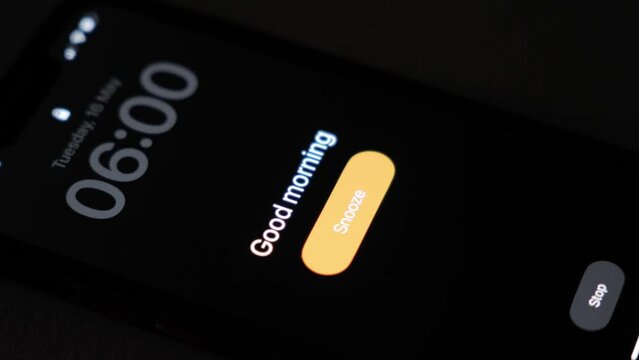 At 6 am, the alarm clock on the phone goes off with the inscription Good morning. Early risers before sunrise. High quality 4k footage