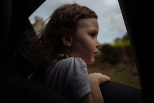 Little girl looks out of the car window