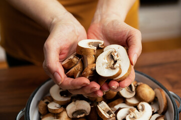 Person holding just cut mushrooms
