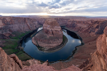 Sunset at the beautiful horseshoe bend with a cloudy sky