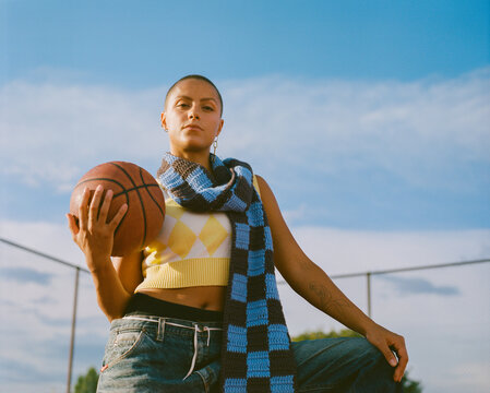 Street Fashion Portrait of Young Woman With Basketball