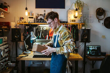 Repairman with box working in garage