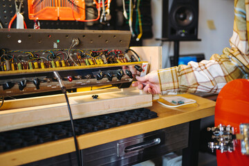 Crop repairman setting amplifier in workshop