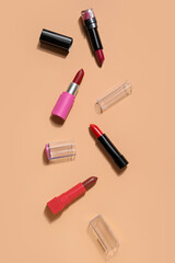 Obraz premium Different lipsticks on beige background
