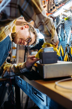 Specialist during work in guitar amplifier repair shop