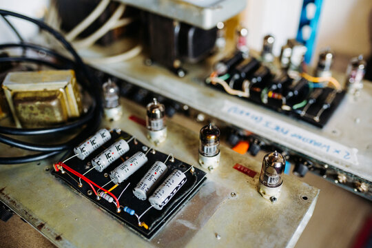 Details of guitar amp placed on table in workshop