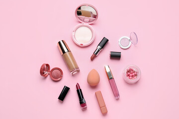 Obraz na płótnie Canvas Decorative cosmetics with lipsticks and sponge on pink background