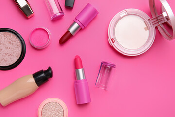 Decorative cosmetics with lipsticks on pink background