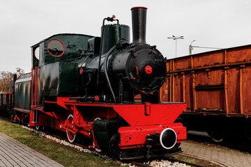 Fototapeta premium Vintage locomotive, steam train in an outdoor depot.