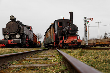 Fototapeta na wymiar Vintage locomotive, steam train in an outdoor depot.