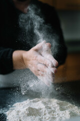 A chef plays with flour before preparing a cake