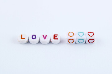Obraz premium Word love and hearts formed by plastic beads