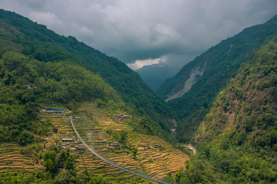 Villages in Nepal with rice fields and suspension bridge