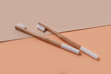 White bamboo toothbrushes on color background