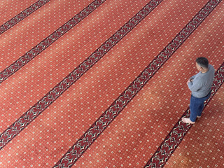 Muslim adult man praying in mosque