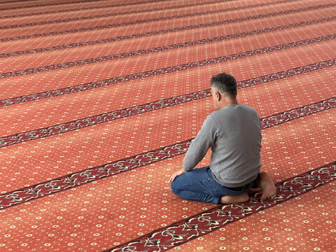 Muslim adult man praying in mosque