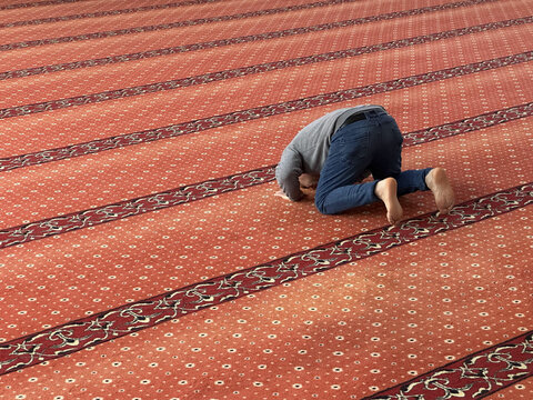Muslim adult man praying in mosque